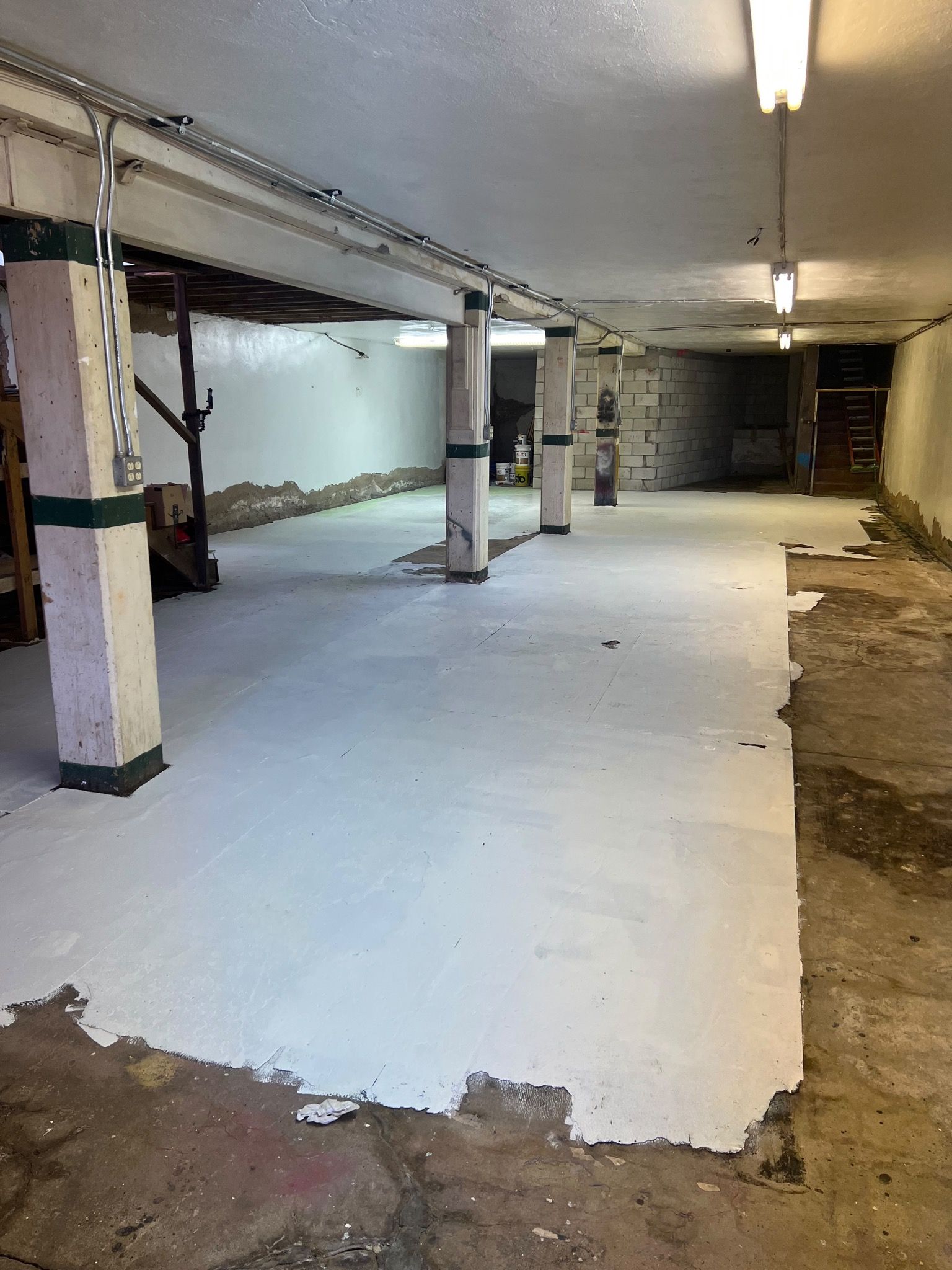 An empty basement floor gets a fresh coat of paint. 