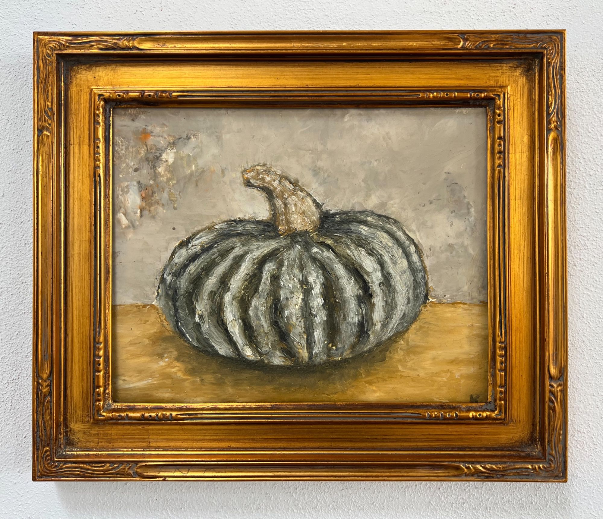 An oil painting of a big round deeply folded green squash centered and taking up most of the frame.