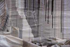 A detail of a handwoven naturally dyed weaving in the shades of stormy clouds and mist